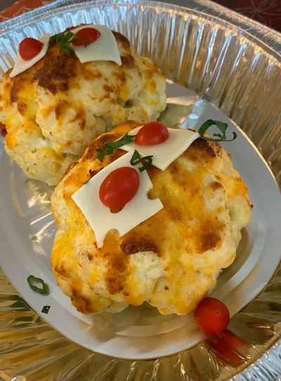 Baked cheese-topped casserole plated from its delivery tray