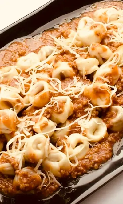 Baked pasta tray finished with melted cheese