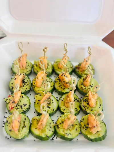 Cucumber canapés with shrimp, avocado and sesame, boxed to travel